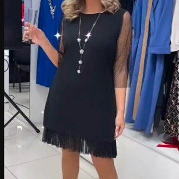 Egy testhezálló ruha oldalsó hasítékokkal és flitteres csipkével